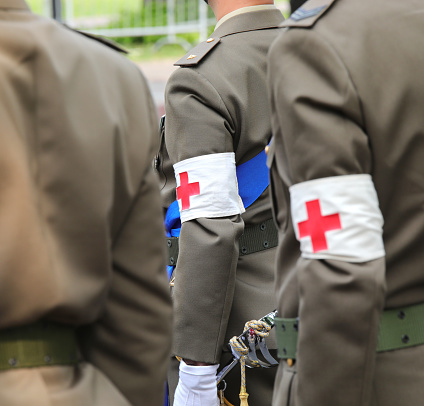 Vicenza, VI, Italy - June 2, 2022: Red cross symbol on the sleeve of the uniform of the army doctor soldiers