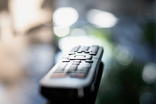TV Remote on the table with high reflective bokeh