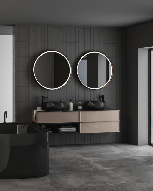 istock Dark bathroom interior with concrete floor, black bathtub and oval mirrors, double sink, side view. 1412743051