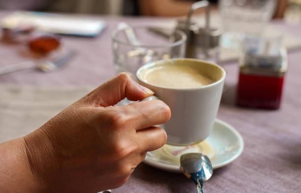 istock Woman holding morning cup of coffee. 1412743721