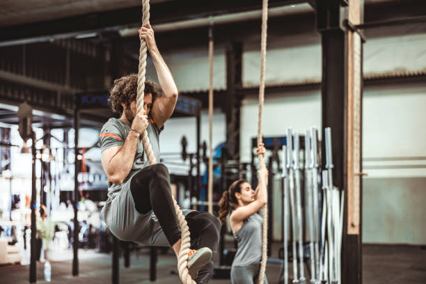 710+ Strong Woman Climbing The Rope On A Gym Stock Photos, Pictures ...
