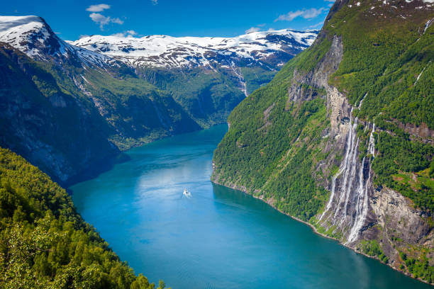 Ferry ship crossing Geirangerfjord and Seven Sisters Waterfalls, Norway Geiranger fjord and Seven Sisters Waterfalls in More og Romsdal, Norway, Northern Europe geirangerfjord stock pictures, royalty-free photos & images