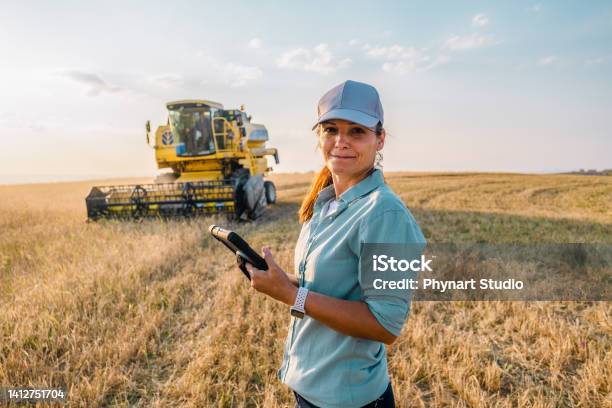 Female Farmer Is Holding A Digital Tablet In A Farm Field Smart Farming Stock Photo - Download Image Now