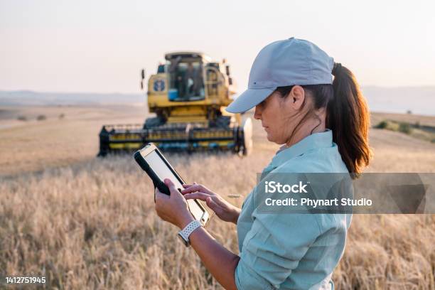 Female Farmer Is Holding A Digital Tablet In A Farm Field Smart Farming Stock Photo - Download Image Now