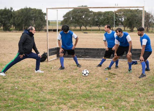 istock Mentally disabled soccer team warming up with coach 1412752870
