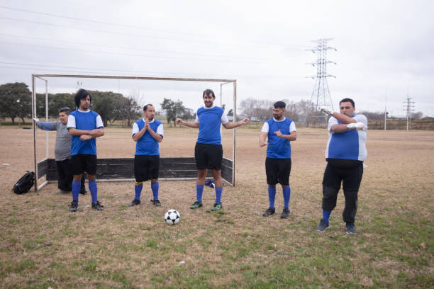 Mentally disabled soccer team warming up at field