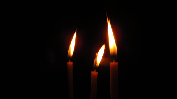 istock three mysterious church candles on a dark background 1412753029