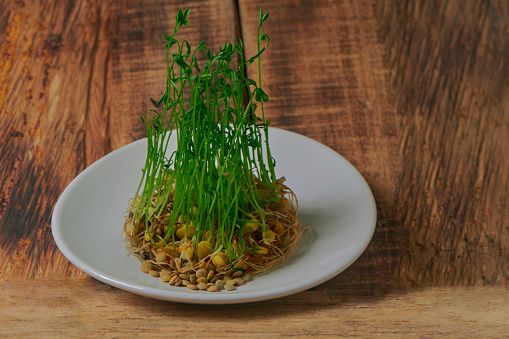 Sprouted lentils on a wooden base