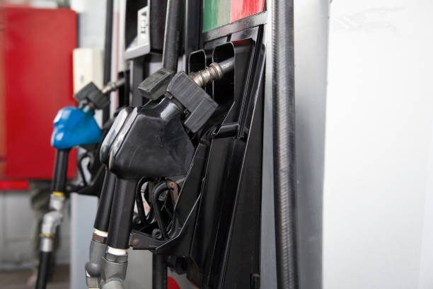 istock Gasoline dispensing guns with space for text. Fuel station. 1412759129