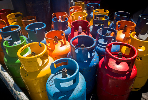 A multiple of gas cylinders painted in different bright colours
