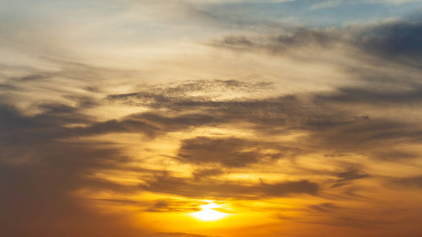 istock the sun behind the clouds and the golden sky 1412761742