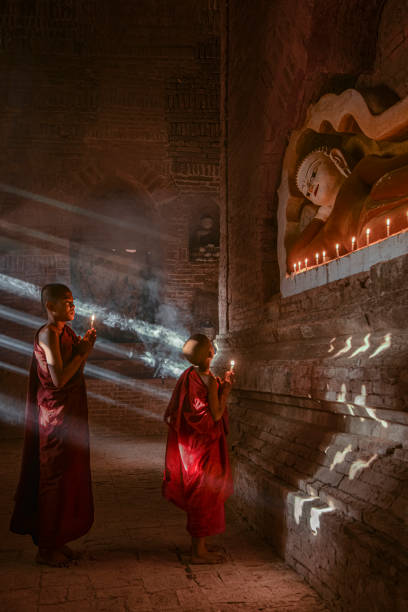 istock Two young buddhist monks praying inside the temple in Bagan, Myanmar 1412762674