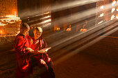 istock Two young buddhist monks praying inside the temple in Bagan, Myanmar 1412762684