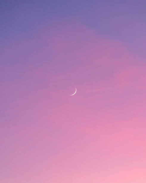istock Crescent moon in a vibrant pink sunset sky 1412764360