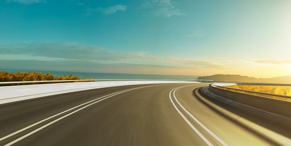 Curvy highway with beautiful seascape background view moving forward motion background,sunrise scene