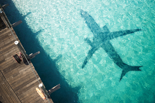 Beautiful tropical beach with airplane shadow. Travel concept
