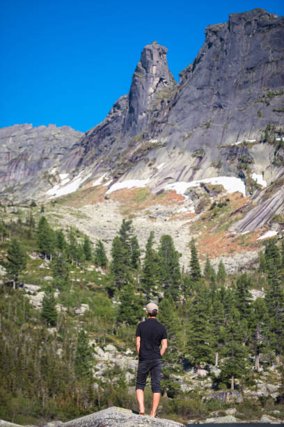 istock young hiker by a lake in mountains 1412771349