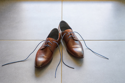 Men's shoes on a tiled floor