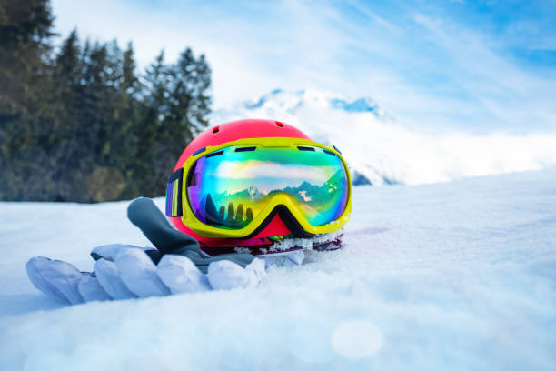 istock Helmet with ski mask and gloves in snow mountain range on back 1412772553