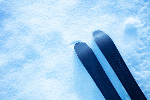 Pair of skis placed on the slope. Winter holiday vacation and skiing concept.