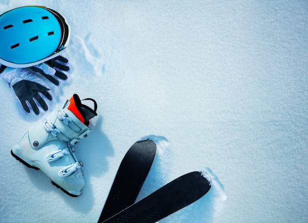 istock White alpine ski boot helmet and gloves in snow from above 1412772593