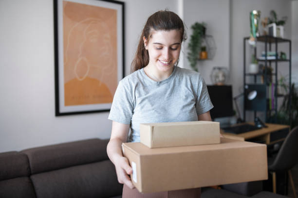 istock Young female holding delivered parcels. 1412772764