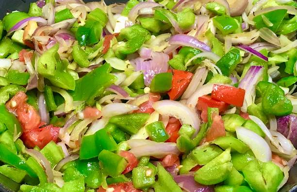 Stir frying veggies for chow mien and fried rice preparations.