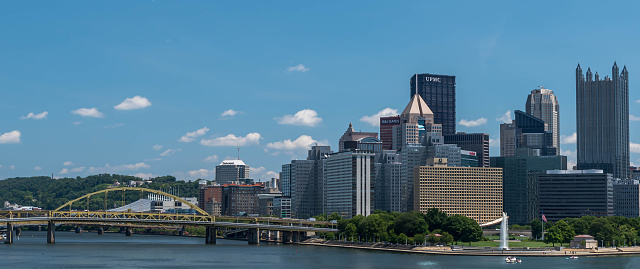 Pittsburgh, Pennsylvania, USA August 9, 2022 A view of downtown, Point State Park and the Fort Duquesne bridge spanning the Allegheny River on a sunny summer day