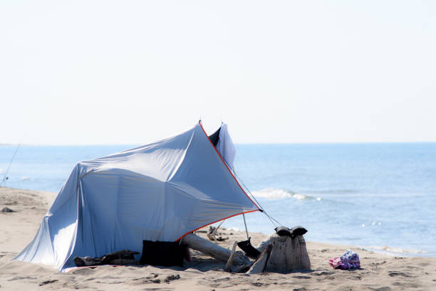 makeshift shelters from the sun on a beach front off the sea