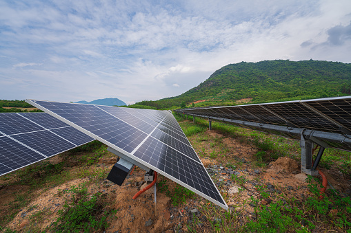 Low angle view  of the solar power farm in Cam Ranh in sunset, which reflect on the solar panel, Cam Lam, Khanh Hoa province, central Vietnam