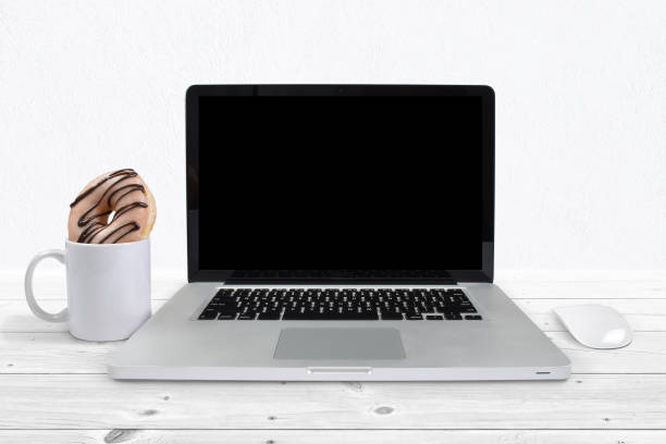 istock Laptop mockup with coffee mug and donut 1412785520