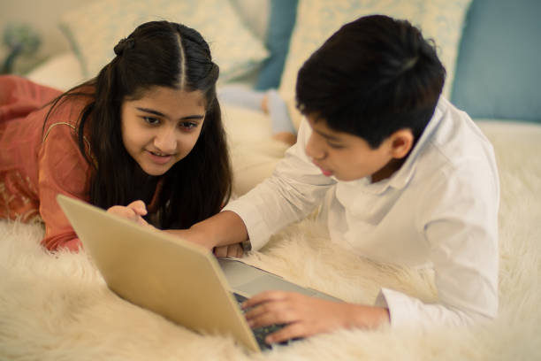 Children Using Laptop Computer At Home