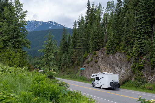 An RV travels along the Trans Canadian Highway towards the Canadian Rockies. Travelling in a RV