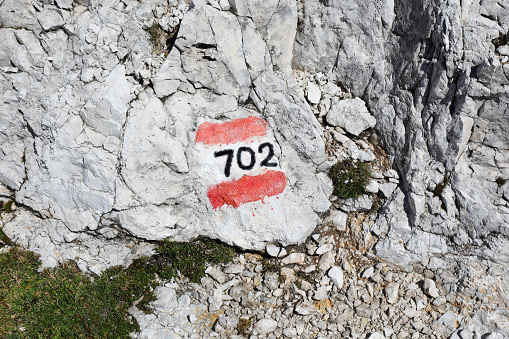 number 702 indicating the path to San Martino di Castrozza town in Italy in the Dolomites