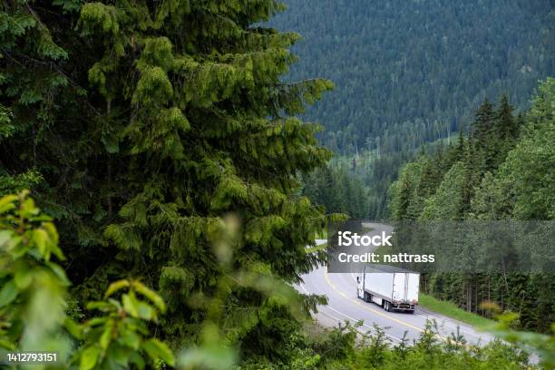 Container Truck Along A Scenic Road Through The Canadian Rockies Stock Photo - Download Image Now