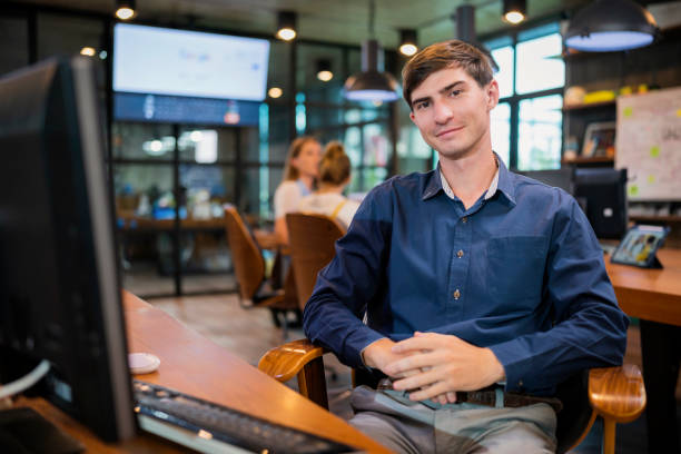 white caucasian office staff  programer continue working in a tech business office,Side View of Concentrate Mature businessman working at desk of a modern business office