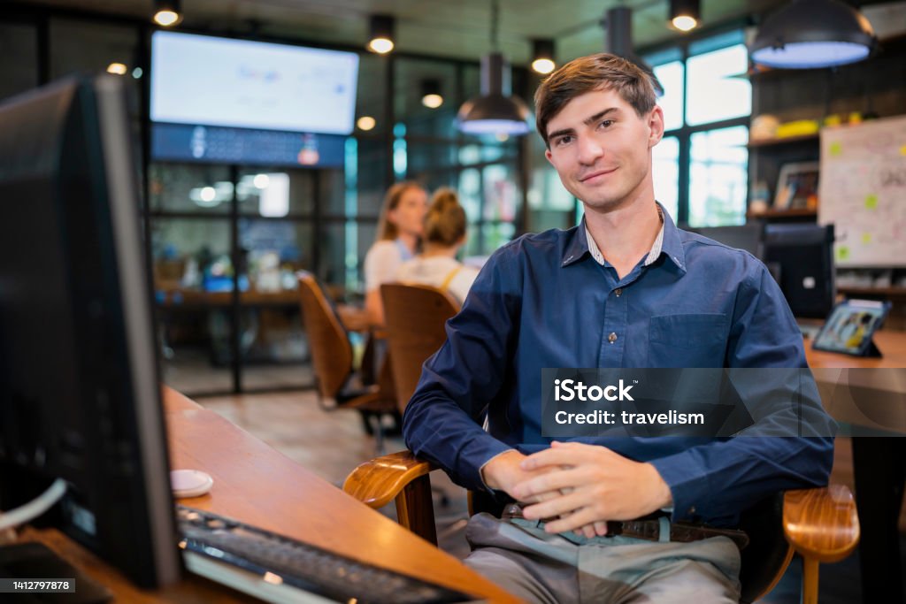 white caucasian office staff  programer continue working in a tech business office,Side View of Concentrate Mature businessman working at desk of a modern business office Computer Software Stock Photo