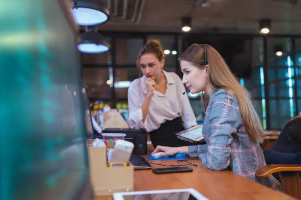 Photo of Build Effective Team Collaboration in financial Tech Business company. A female Software Developer decision on design time line and progress for custom software in a tech business office