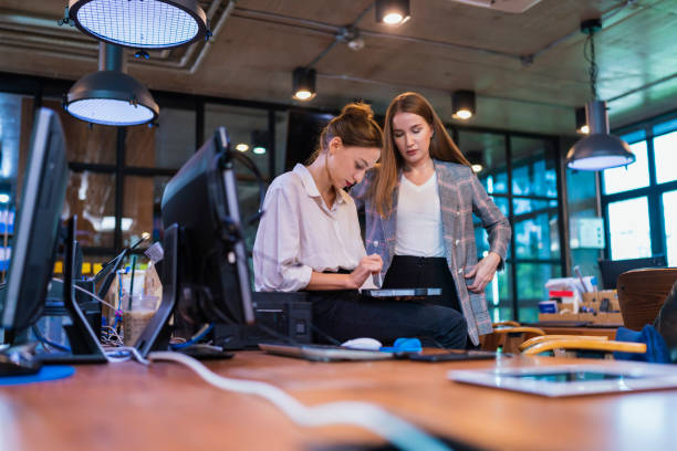 istock Build Effective Team Collaboration in financial Tech Business company. A female Software Developer decision on design time line and progress for custom software in a tech business office 1412797941
