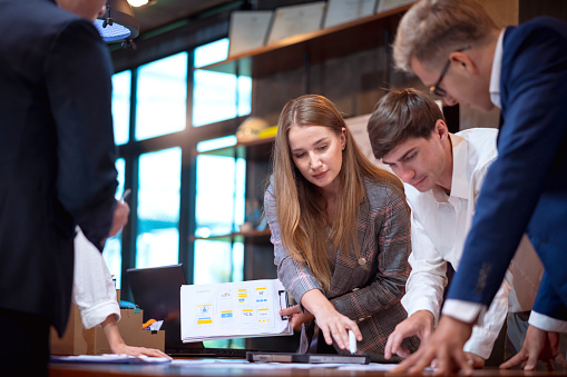 Rebranding Help Your Business Move into present success today. Business Development Teamwork standing discuss during a meeting conference about improve rebranding and strategy setting by focusing on the future target market in a modern interior business office.