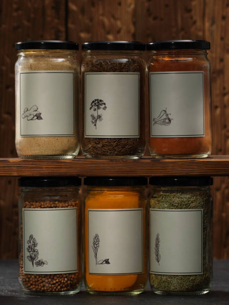 istock Dried spices in glass jars displayed on shelves. Assorted ground spices 1412798332