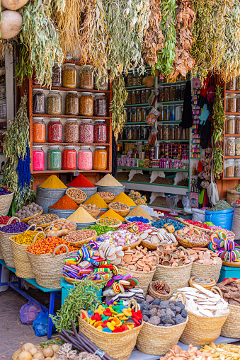 Many different colour spices in glass jars in a spices market in Marrakesh, Morocco