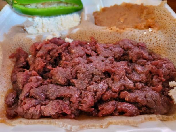 istock Ethiopian food kitfo raw beef and injera bread 1412801244