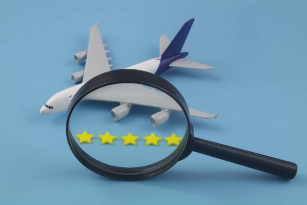 istock Airplane with five stars and magnifying glass on blue background. 1412805534
