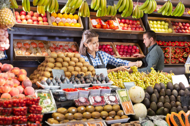 istock Shop assistants working in fruit and vegetable shop 1412805598