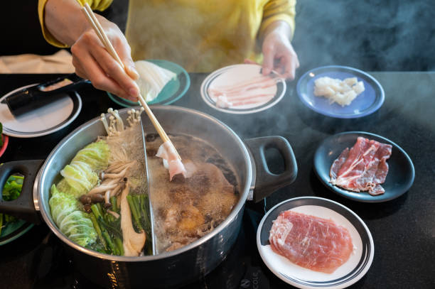 istock Woman boiling meat in hotpot. 1412805602