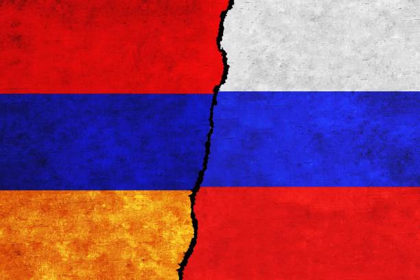 istock Russia and Armenia painted flags on a wall with a crack. 1412805691