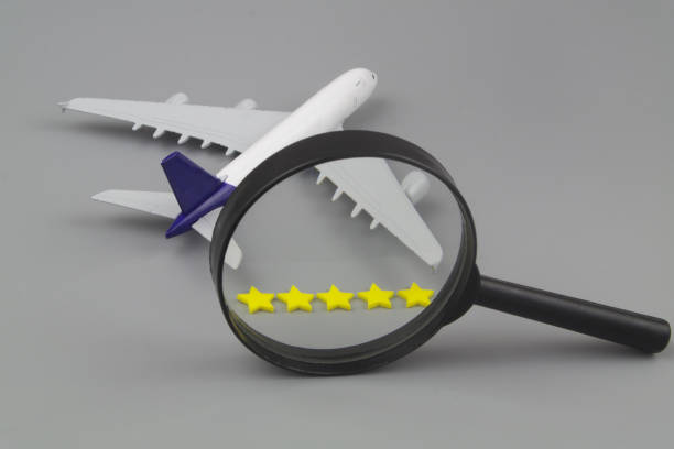 istock Airplane with five stars and magnifying glass on gray background. 1412805873