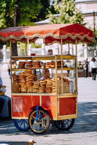 food stand in Istanbul selling Turkish Bagel food stand selling Simit, which is a round crusted bread usually topped with sesame seeds simit istanbul stock pictures, royalty-free photos & images
