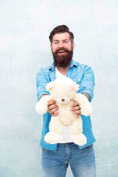 istock Valentines day. Present for your partner. Man with beard happy face carry gift toy. Playful mood. How to take care of someone. Toys shop concept. Happy birthday. Handsome hipster hold lovely bear toy 1412807708